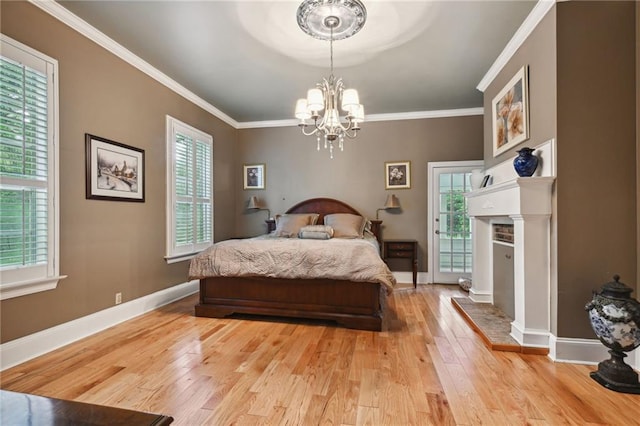 bedroom with multiple windows, light hardwood / wood-style floors, and ornamental molding