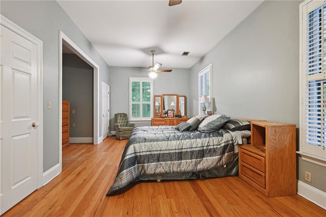 bedroom with ceiling fan and light hardwood / wood-style flooring