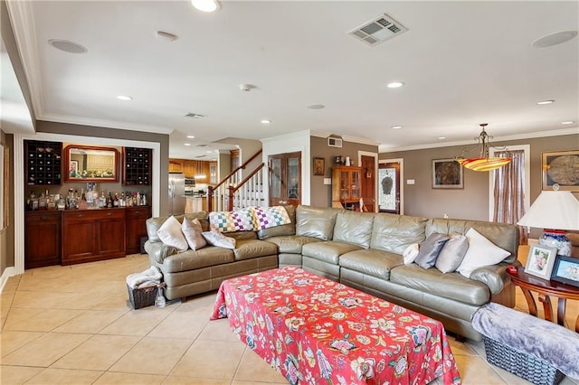 tiled living room featuring bar area and crown molding