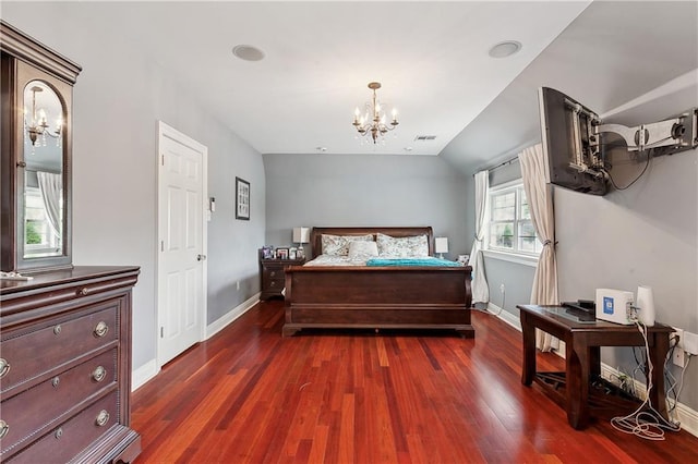 bedroom featuring dark wood-type flooring and an inviting chandelier