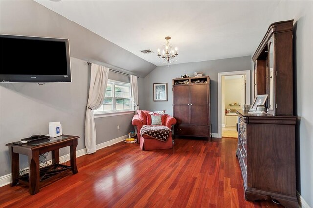 living area with lofted ceiling, an inviting chandelier, and dark hardwood / wood-style floors