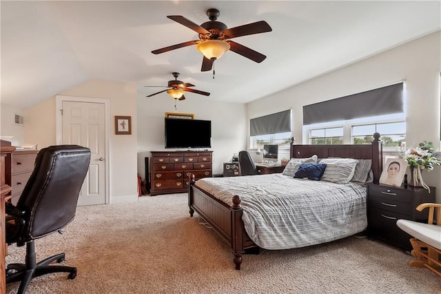 bedroom with ceiling fan, carpet floors, and vaulted ceiling