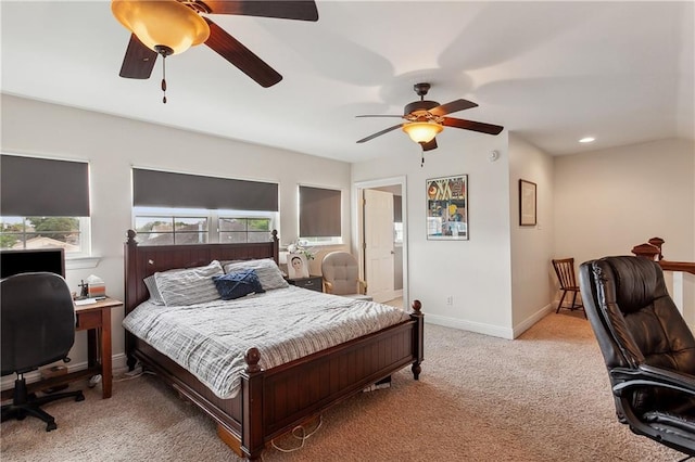 carpeted bedroom featuring ceiling fan and multiple windows