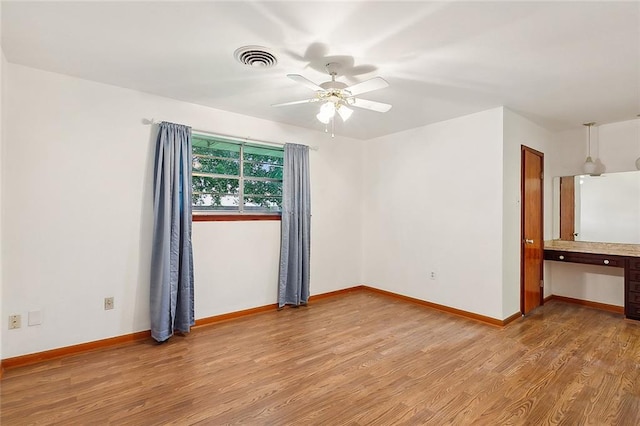 empty room featuring light wood-type flooring and ceiling fan