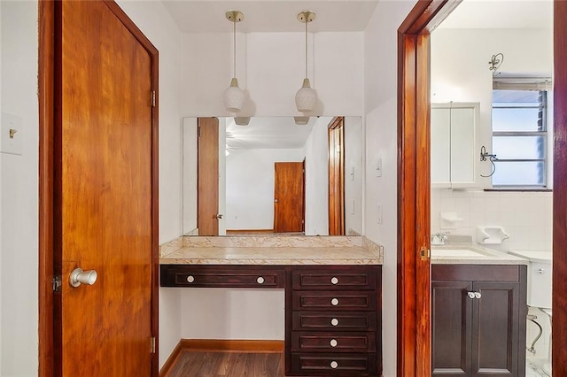 bathroom with wood-type flooring, backsplash, and vanity