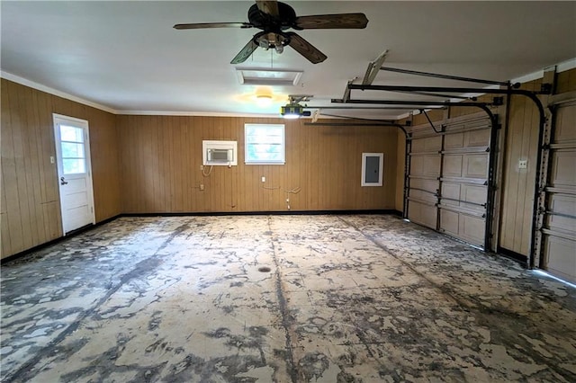 garage with a garage door opener, ceiling fan, and wooden walls