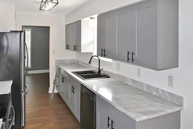 kitchen featuring dark hardwood / wood-style floors, stainless steel appliances, gray cabinetry, and sink