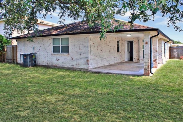 back of house featuring a yard, a patio, and central AC