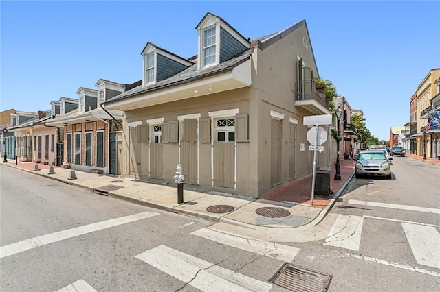 exterior space with uncovered parking, a residential view, and stucco siding