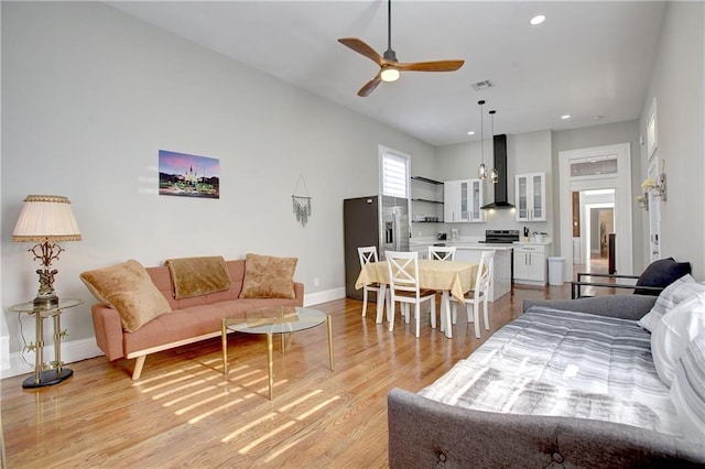 living room featuring ceiling fan and light wood-type flooring