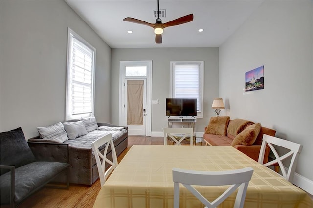 living room with light wood-type flooring and ceiling fan