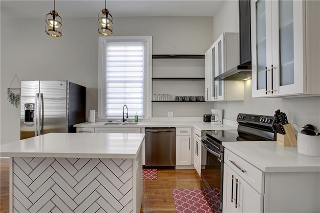 kitchen featuring a kitchen island, appliances with stainless steel finishes, sink, hardwood / wood-style flooring, and white cabinets