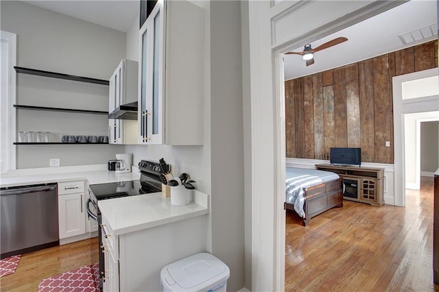 kitchen featuring white cabinets, light hardwood / wood-style flooring, range with electric stovetop, ceiling fan, and stainless steel dishwasher