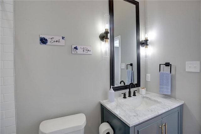 bathroom with toilet and vanity