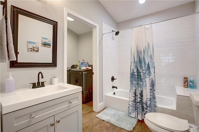 full bathroom featuring vanity, shower / tub combo with curtain, independent washer and dryer, and wood-type flooring