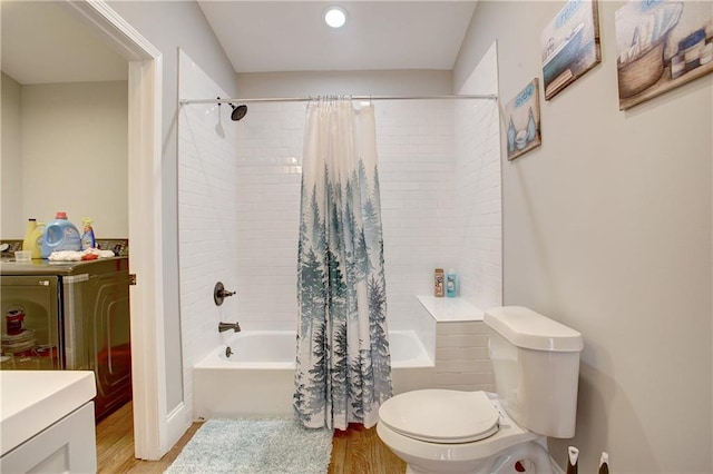 full bathroom with hardwood / wood-style floors, toilet, shower / tub combo, and vanity