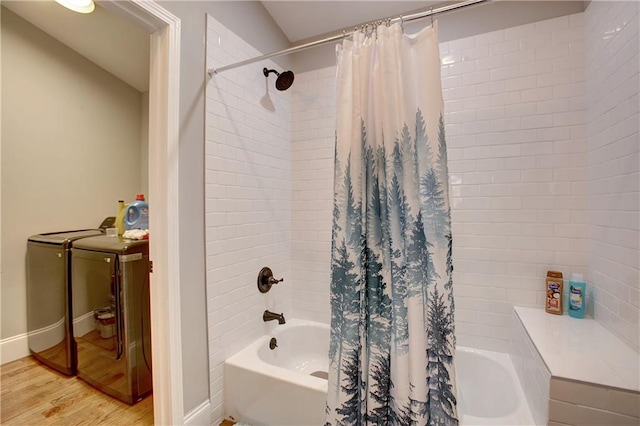 bathroom with shower / bath combo with shower curtain, separate washer and dryer, and hardwood / wood-style floors