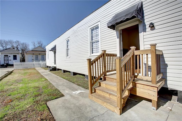 exterior space featuring a garage and a lawn