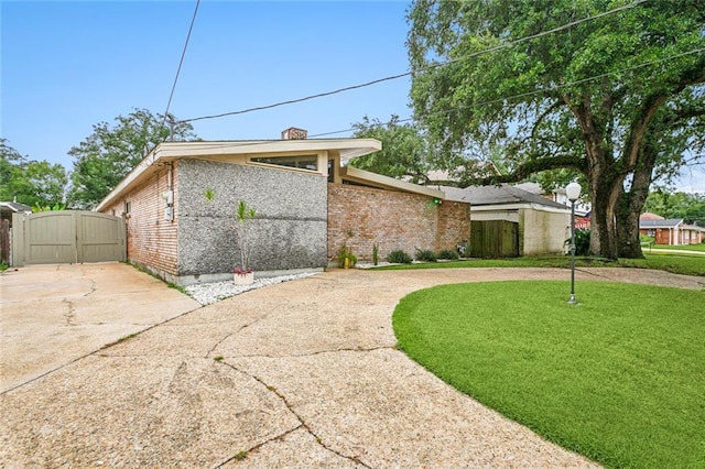 view of property exterior with a yard