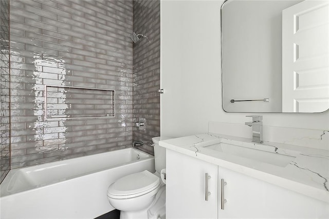 full bathroom featuring tiled shower / bath combo, vanity, and toilet