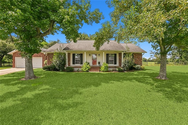 ranch-style house featuring a front yard and a garage