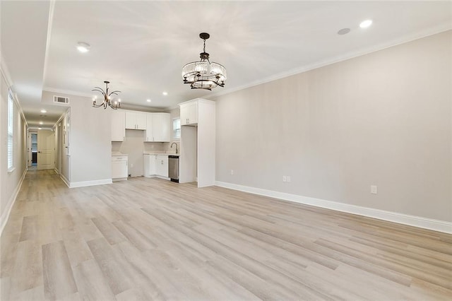 unfurnished living room with sink, light wood-type flooring, crown molding, and a chandelier