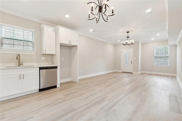 kitchen featuring white cabinetry, light wood-type flooring, decorative light fixtures, stainless steel dishwasher, and a chandelier