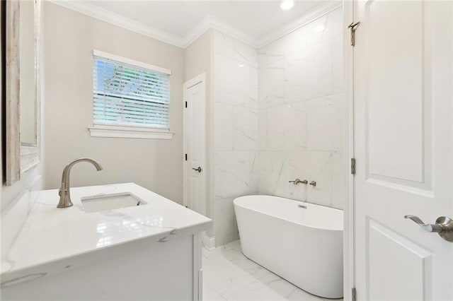 bathroom featuring a bathtub, crown molding, and vanity