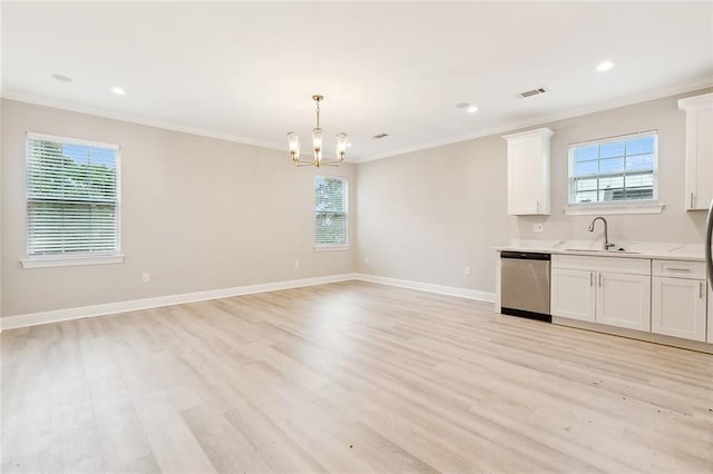 kitchen with plenty of natural light, dishwasher, and white cabinets