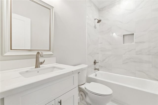 full bathroom with tiled shower / bath, vanity, and toilet