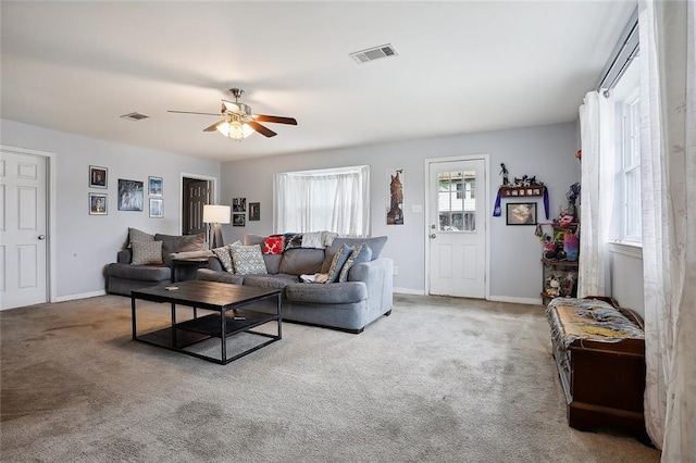 carpeted living room with ceiling fan