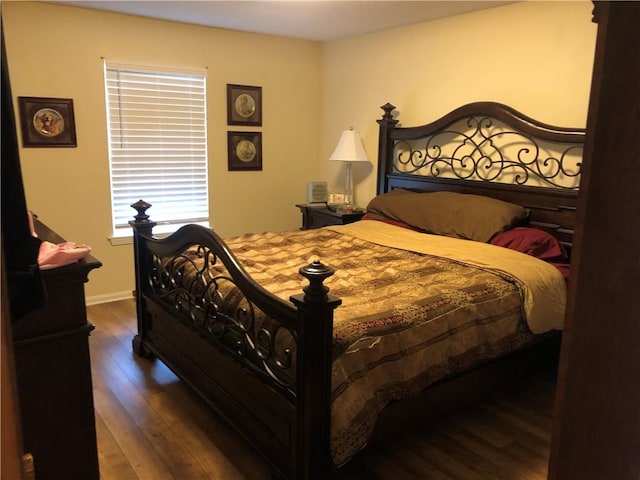 bedroom with dark hardwood / wood-style flooring