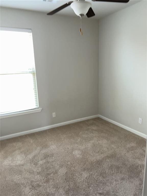 empty room featuring ceiling fan and carpet flooring