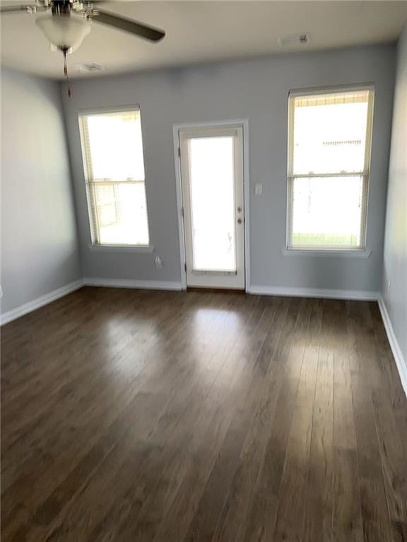 interior space featuring ceiling fan and dark wood-type flooring