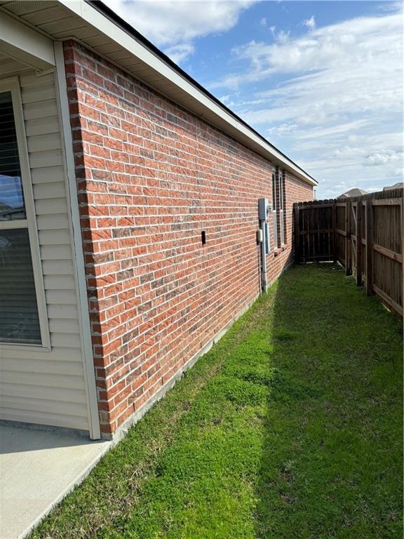 view of side of home with a lawn