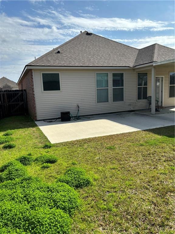 back of property with a patio and a yard