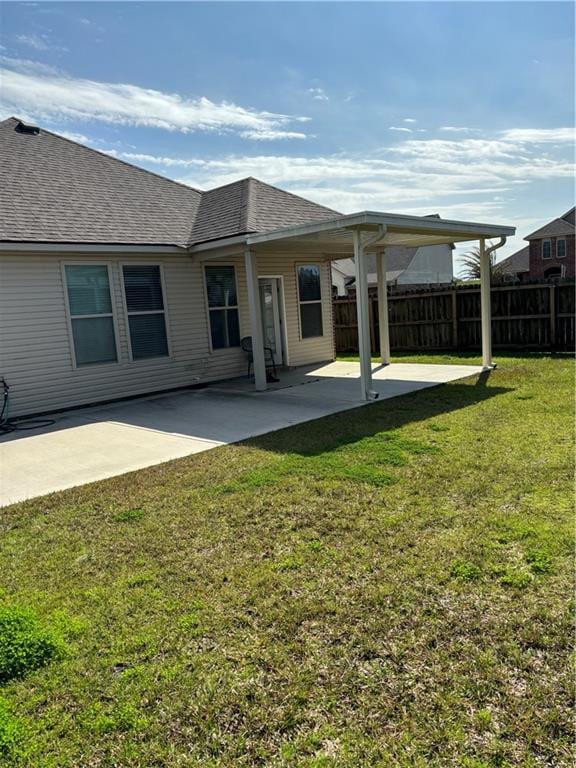 rear view of property with a yard and a patio