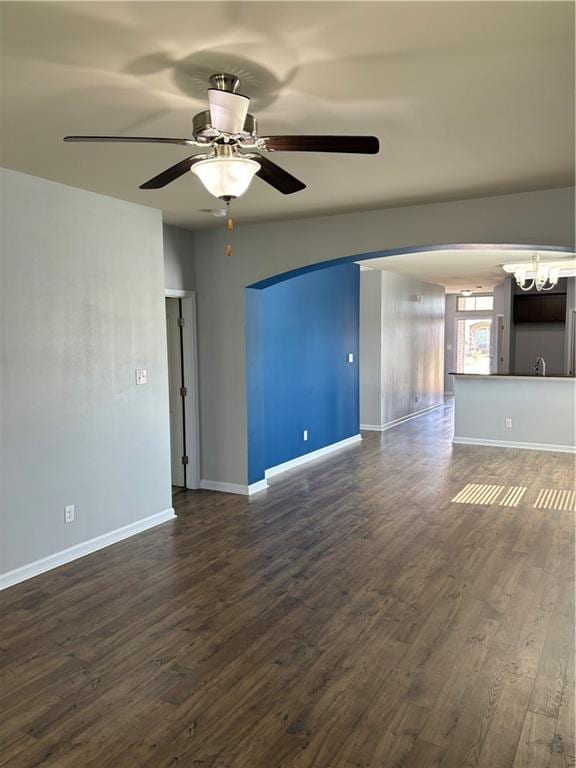 unfurnished room with ceiling fan and dark hardwood / wood-style floors