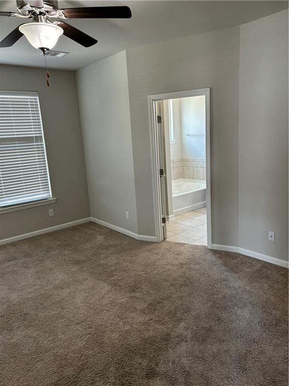 carpeted empty room featuring ceiling fan