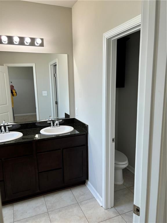 bathroom featuring tile patterned flooring, vanity, and toilet