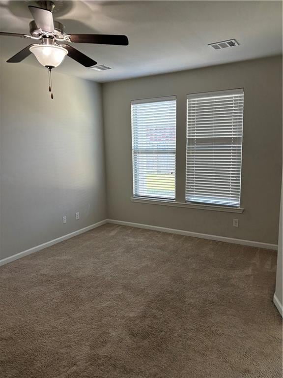 empty room featuring carpet and ceiling fan