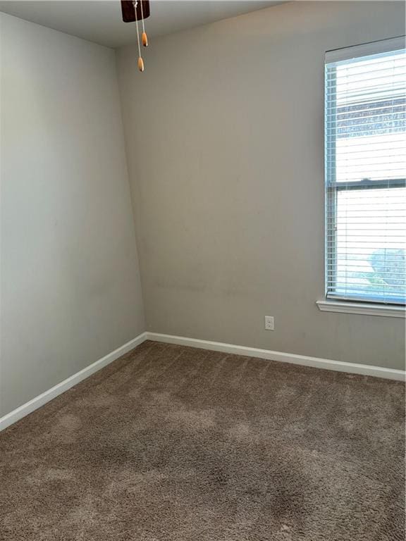 carpeted empty room featuring ceiling fan