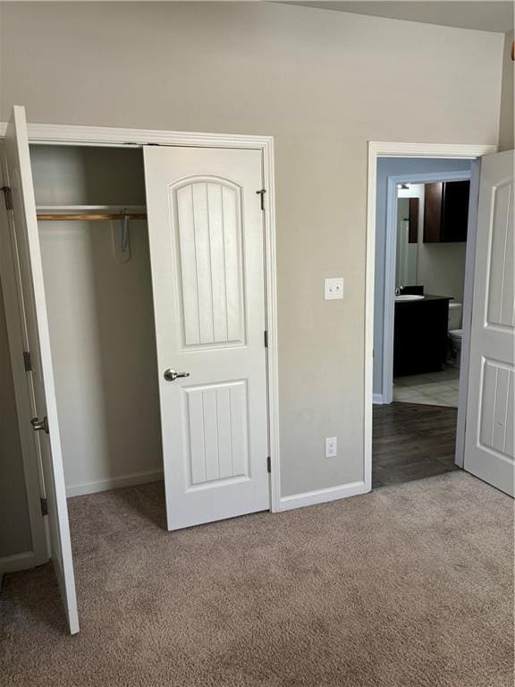 unfurnished bedroom with carpet floors and a closet