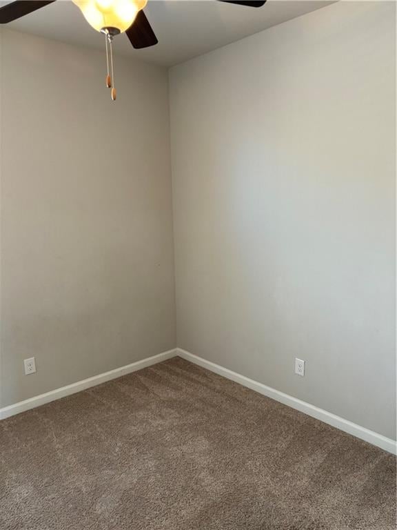 spare room with ceiling fan and carpet flooring