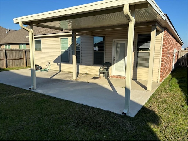 rear view of property featuring a yard and a patio