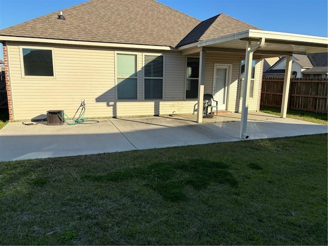 back of house with a lawn and a patio area