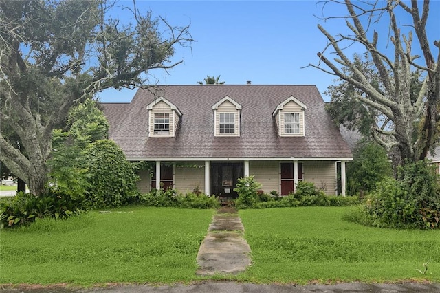 cape cod home with a front lawn