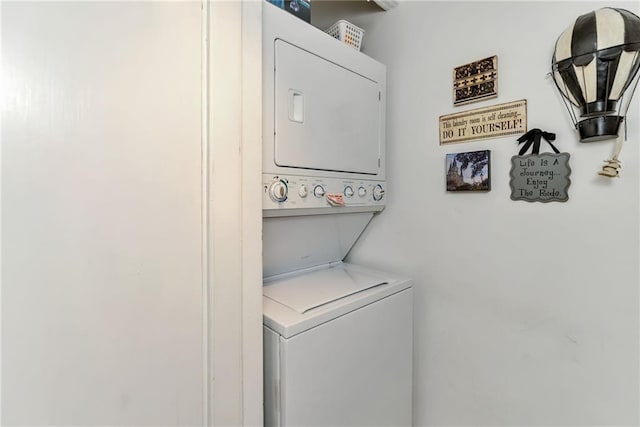 clothes washing area featuring stacked washer / dryer