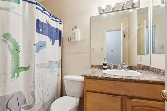 bathroom featuring walk in shower, toilet, and vanity