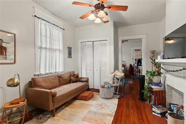 living room with ceiling fan and hardwood / wood-style flooring